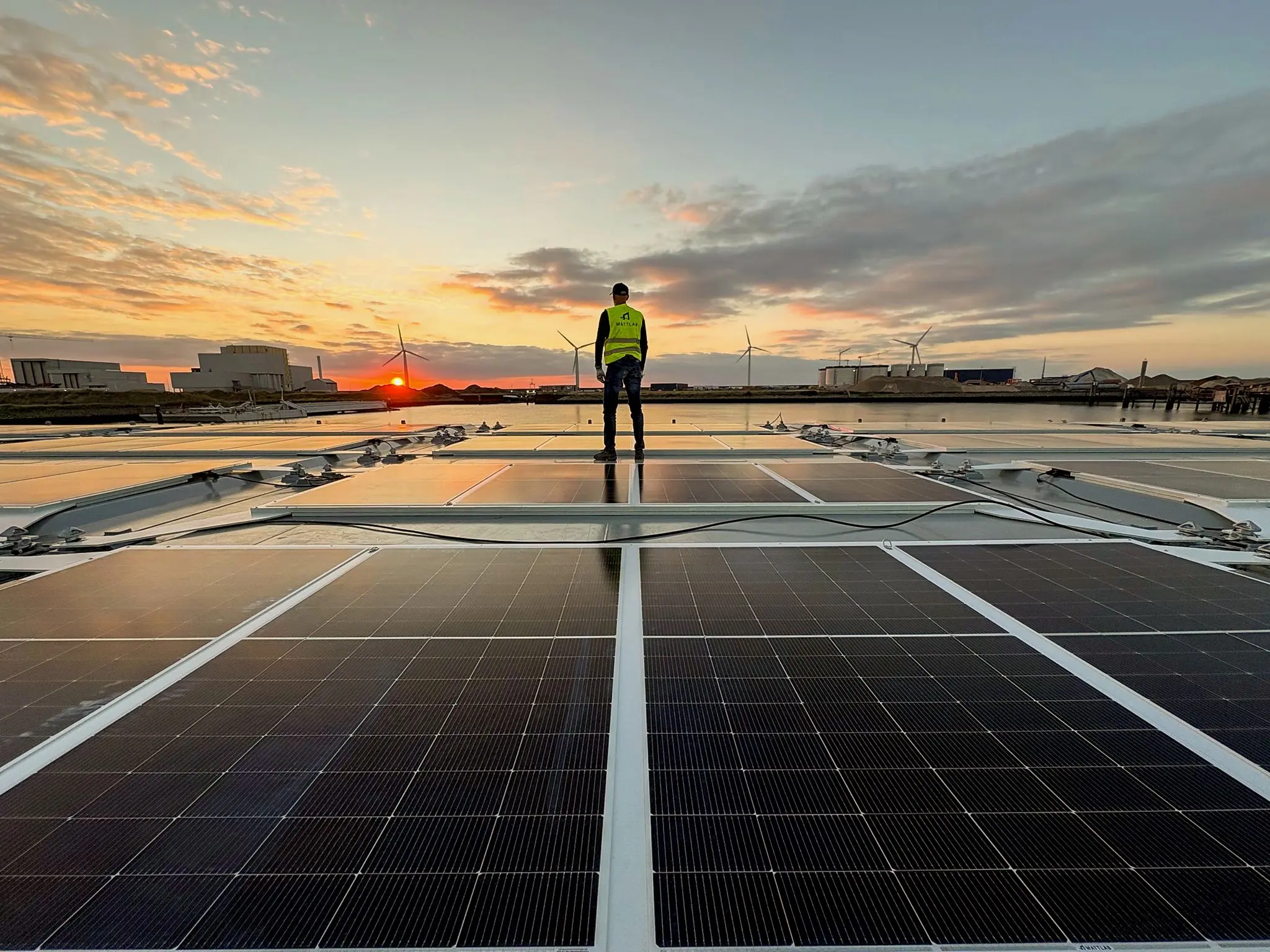 Wattlab engineer on Solar Flatrack panels at sunset in the Port of Rotterdam